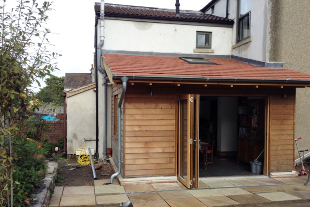 This Kitchen timber framed extension was quickly assembled with little disruption. It was super-insulated and clad in western red cedar. Kitchen extension super-insulated and clad in western red cedar